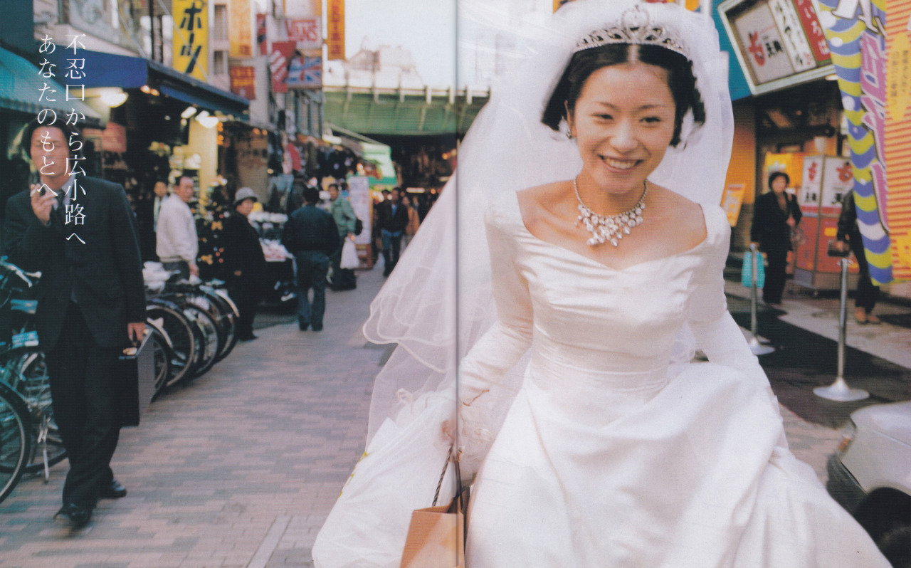a magazine spread of shiina ringo in a wedding dress walking down a street